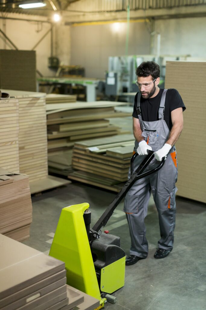 Handsome young man working in the furniture factory